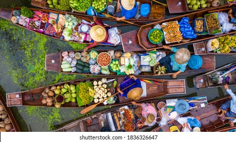 Aerial view famous floating market in Thailand, Damnoen Saduak floating market, Farmer go to sell organic products, fruits, vegetables and Thai cuisine, Tourists visiting by boat, Ratchaburi, Thailand - Shutterstock ID 1836326647