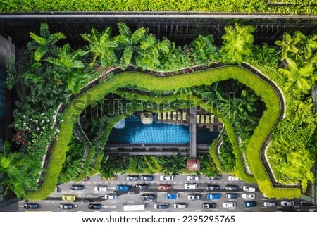 Aerial view of the famous hotel in Singapore. This building has a jungle like green facade.