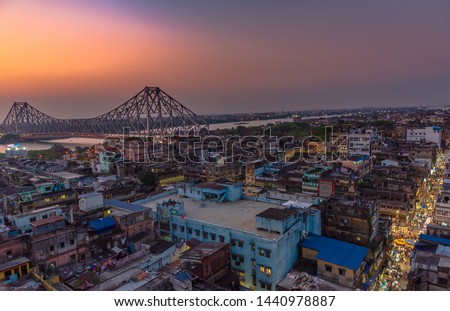 Aerial View of Famous Howrah bridge/ Rabindra Setu along with Burrabazar/ Barabazar area at the time of Blue hour.