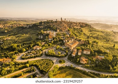 Aerial view of famous medieval San Gimignano hill town with its skyline of medieval towers, including the stone Torre Grossa. Province of Siena, Tuscany, Italy.
