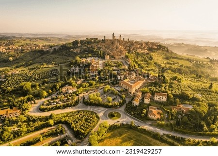 Aerial view of famous medieval San Gimignano hill town with its skyline of medieval towers, including the stone Torre Grossa. Province of Siena, Tuscany, Italy.