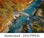 Aerial view of the famous Portaikos arched, stonebridge in Pyli, Trikala, Greece, during golden autumn time