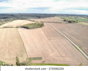 Aerial View Of Farm Land. Empty Crop Fields Waiting For Plowing. Plowed Fields Of Estonia. Drone Photo. Grain Fields In Europe. Field Work Being Done In Spring. Cultivated Land Which Looks Dry