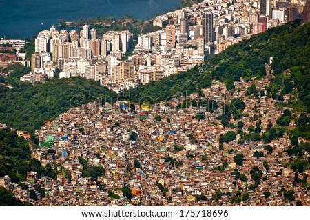Aerial view of Favela da Rocinha, Biggest Slum in Brazil on the Mountain in Rio de Janeiro, and Skyline of the City behind