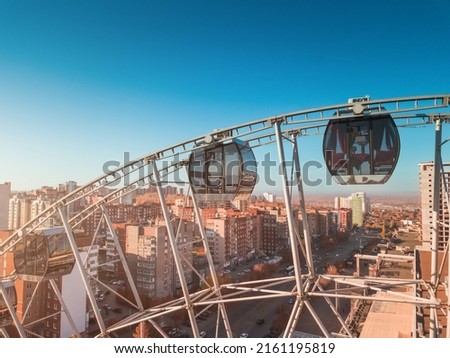 Aerial view of Ferris wheel in city district. Entertainment business concept