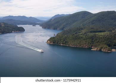 Aerial view of the Ferry traveling between the islands during a sunny summer day. Taken in Sunshine Coast, BC, Canada.