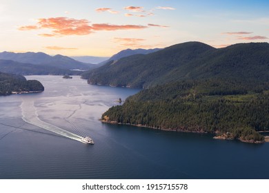Aerial view of the Ferry traveling between the islands during a sunny summer evening. Sunset Sky Art Render. Taken in Sunshine Coast, BC, Canada.