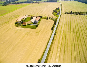 Aerial View To Fields With Farm House And Road. 