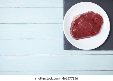 An Aerial View Of A Fillet Of Rump Steak Meat On A Painted Wooden Kitchen Counter Background Forming A Page Border