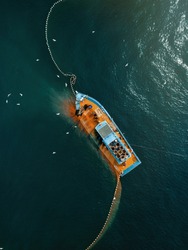 Aerial View Fisherman Catching Fish Using Net At The Ocean. Selective Focus,contains Grain And Noise.
