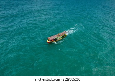 Aerial view of fishing boat going out to the sea.