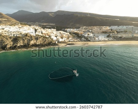 Aerial view of a fishing boat in the morning near Moro Jable beach in Fuerteventura Spain. 