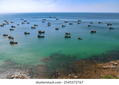 Aerial view of fishing boats scattered across the turquoise waters of Phu Quoc, seen from a cable car. - Powered by Shutterstock