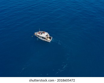 Aerial View Of A Fishing Vessel In The Blue Sea Off The Coast Of Calabria, Italy