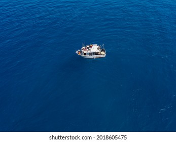 Aerial View Of A Fishing Vessel In The Blue Sea Off The Coast Of Calabria, Italy