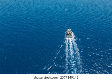 Aerial view of Fishing vessel trawler catch fish in open sea