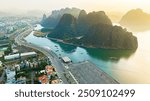 Aerial view floating fishing village and rock island, Halong Bay, Vietnam, Southeast Asia. UNESCO World Heritage Site. Junk boat cruise to Ha Long Bay. Popular landmark, famous destination of Vietnam