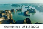 Aerial view floating fishing village and rock island, Halong Bay, Vietnam, Southeast Asia. UNESCO World Heritage Site. Junk boat cruise to Ha Long Bay. Popular landmark, famous destination of Vietnam