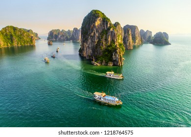 Aerial view floating fishing village and rock island, Halong Bay, Vietnam, Southeast Asia. UNESCO World Heritage Site. Junk boat cruise to Ha Long Bay. Popular landmark, famous destination of Vietnam - Shutterstock ID 1218764575