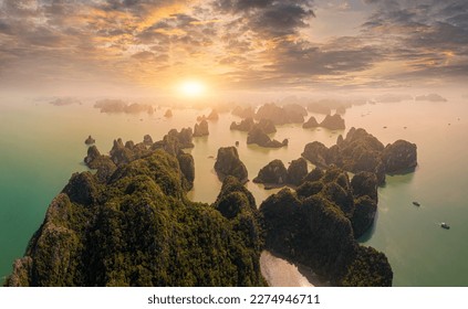 Aerial view floating fishing village and rock island, Ha Long Bay, Vietnam, Southeast Asia. UNESCO World Heritage Site. Junk boat cruise to Ha Long Bay. Popular landmark, famous destination of Vietnam