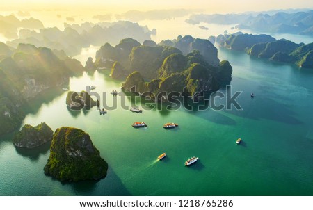 Aerial view floating fishing village and rock island, Halong Bay, Vietnam, Southeast Asia. UNESCO World Heritage Site. Junk boat cruise to Ha Long Bay. Popular landmark, famous destination of Vietnam
