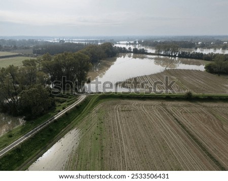 Similar – Image, Stock Photo Agriculture. Cropped shot of view businessman farmer in rubber boots walks along plowed field. Agronomist checking and analyses fertile soil on sunrise. Agribusiness.