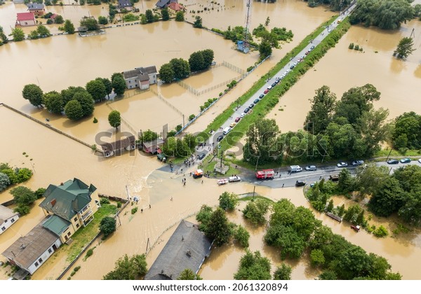 Aerial view of flooded houses and\
rescue vehicles saving people in Halych town, western\
Ukraine.
