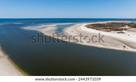Aerial view of flowing water amidst the dunes.