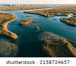 An aerial view of the flowing water in grasslands in bright sunlight in Murrells Inlet, Georgetown county, South Carolina, United States
