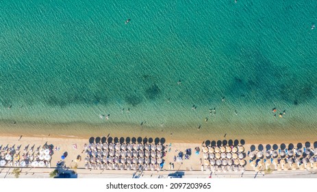 Aerial View From Flying Drone Of People Crowd Relaxing On Beach In Greece.