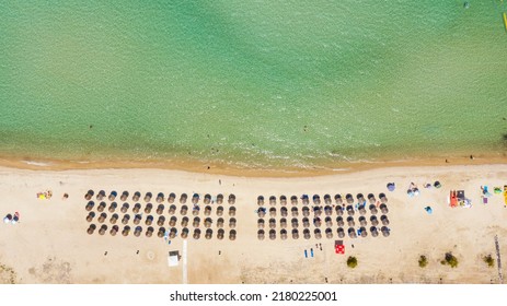 Aerial View From Flying Drone Of People Crowd Relaxing On Beach In Greece.