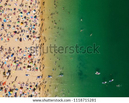 Similar – Aerial View From Flying Drone Of People Crowd Relaxing On Algarve Beach In Portugal