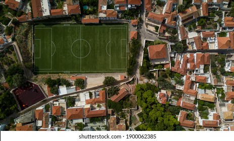 An Aerial View Of The Football Field And Buildings Of Greek Hydra Island