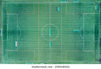 An aerial view of a football field with painted lines and goalposts