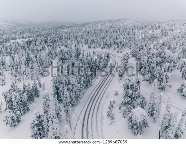 Aerial view of forest covered with snow\
in Finland, Lapland. Beautiful winter\
landscape.