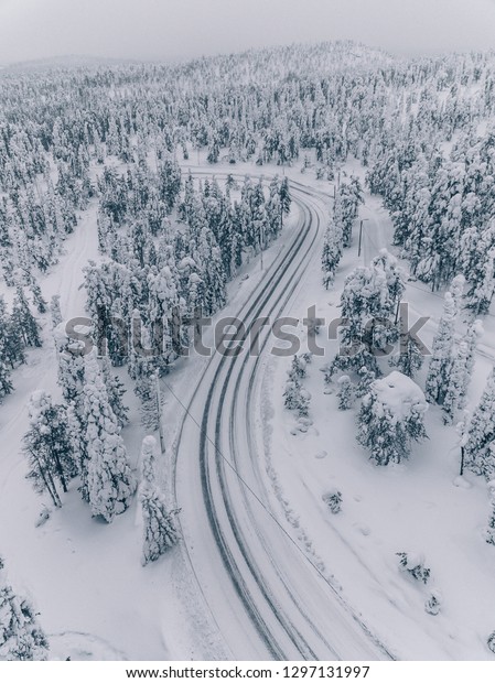 Aerial view of forest covered with snow\
in Finland, Lapland. Beautiful winter\
landscape.