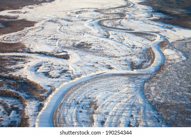 Aerial view the forest river during winter day.