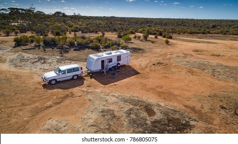 Aerial View Of Four Wheel Drive Vehicle And Caravan Camped In The Outback Of Australia.