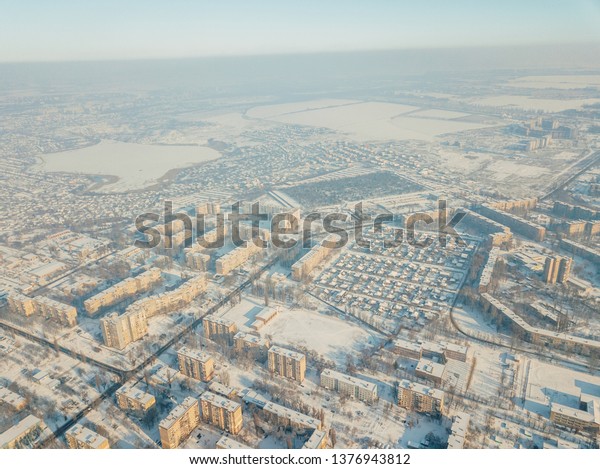 Aerial view of a freeway intersection\
Snow-covered in winter.
