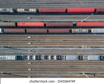 Aerial View Of Freight Train Wagons On Large Railway Track Field. Concept Of Modern Logistics.