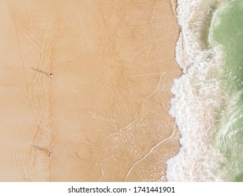 Aerial View Of Friends Walking Along Florida Beach 