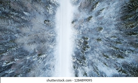 Aerial View Of Frozen Road And Nordic Forest Covered By Snow. Winter In Finland