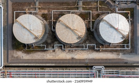 Aerial view fuel reservoirs petroleum industrial zone metal exhaust pipes oil refinery factory, Oil storage tank farm storage chemical petroleum petrochemical refinery product terminal company.