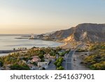 Aerial view of Fujairah coastline with beach hotels, wild beach and mountains, UAE