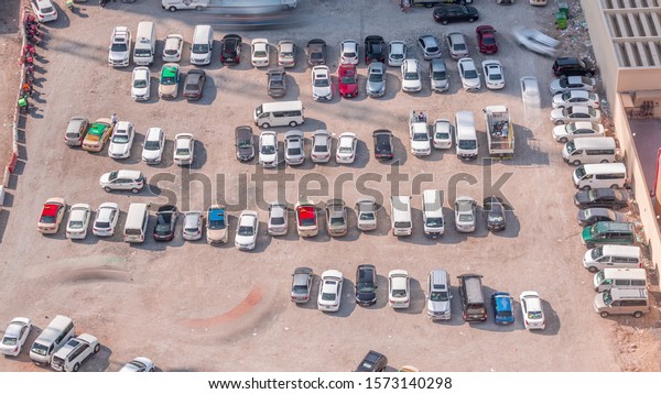Aerial view full cars at large outdoor parking
lots timelapse in Dubai, UAE. Office and recidential parking
congestion and crowded parking lot with other cars try getting in
and out, finding parking