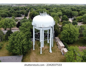 Aerial view of a full size water tower with installed telecom antennas