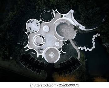 Aerial View of a Futuristic Circular Building in a Forest Setting. - Powered by Shutterstock