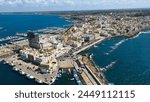 Aerial view of Gallipoli, drone view at the old town with fort, ramparts and harbor, Lecce province, Salento peninsula, Puglia, south Italy. Gallipoli historic center seen from another perspective.