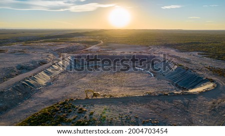 aerial view of garbage dump in sunset