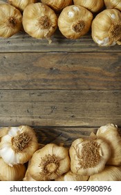 Aerial View Of Garlic Bulbs Arranged On A Rustic Wooden Kitchen Counter Background Forming A Page Frame